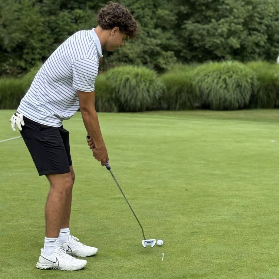 young man about to swing golf club